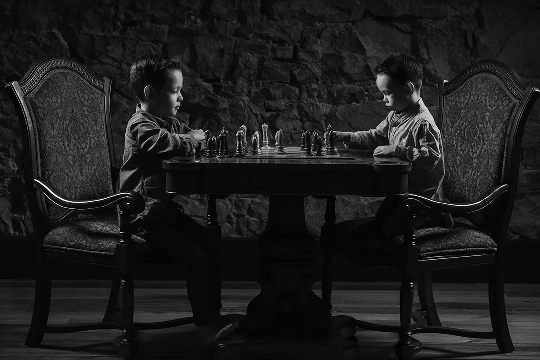 portrait of 3 brothers playing chess - Calgary family photography