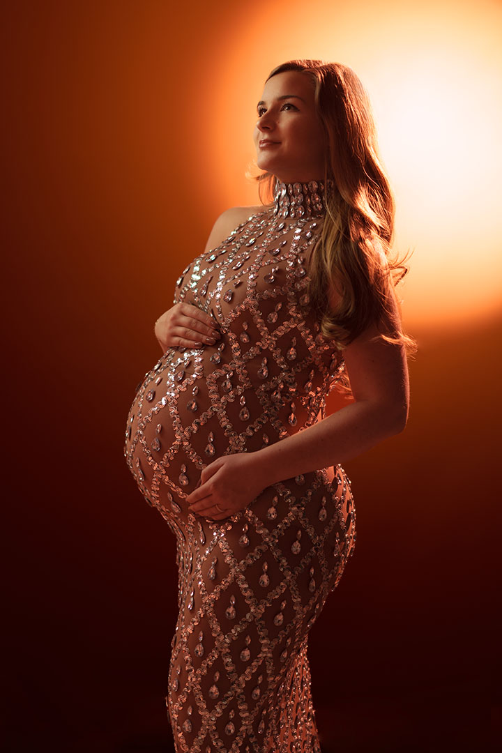pregnant woman set against sun created in studio - Calgary maternity photographer